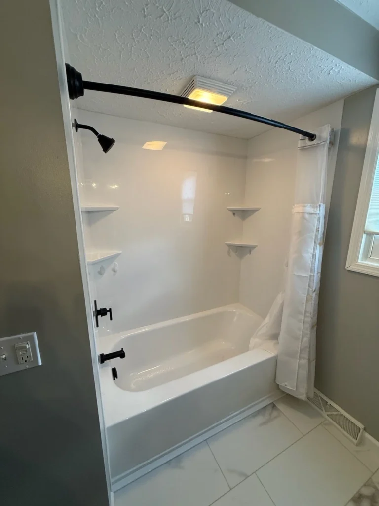White bathroom with shower and bathtub combo.