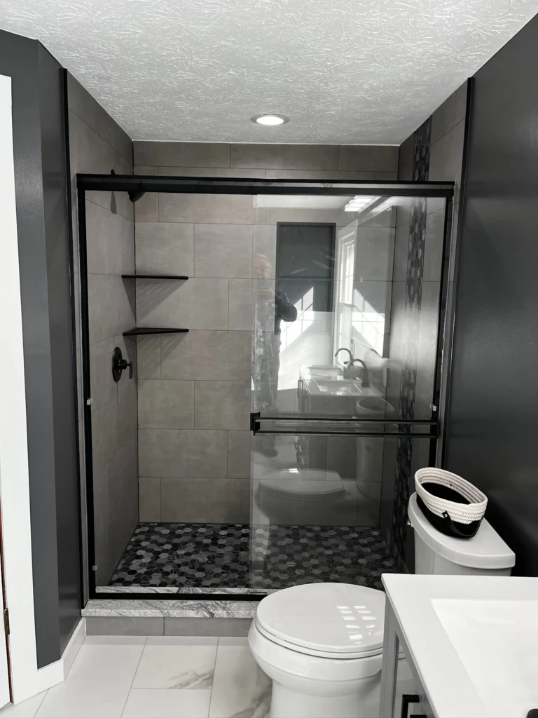 Modern bathroom with glass shower enclosure.