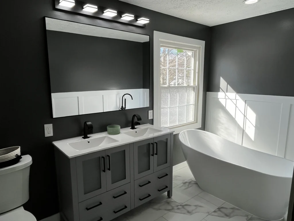 Modern bathroom with freestanding tub and vanity.