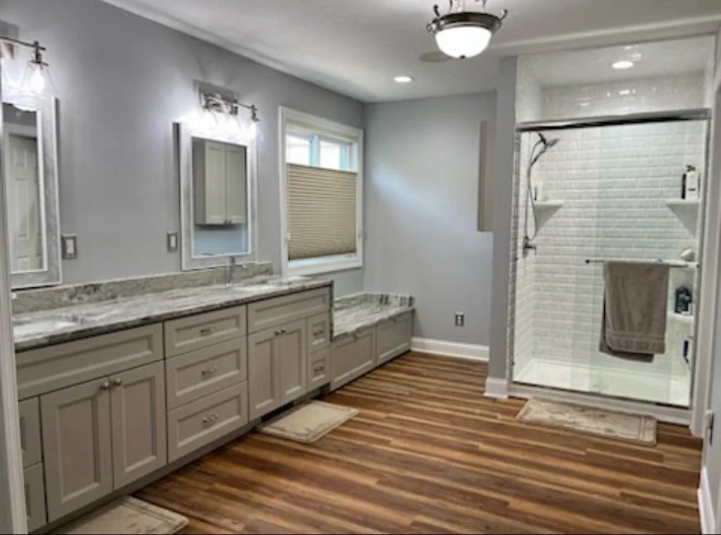 Modern bathroom with wooden floor and shower.
